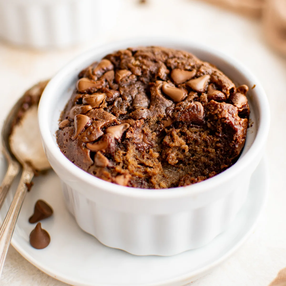 Scoop taken out of a ramekin of chocolate baked oats.