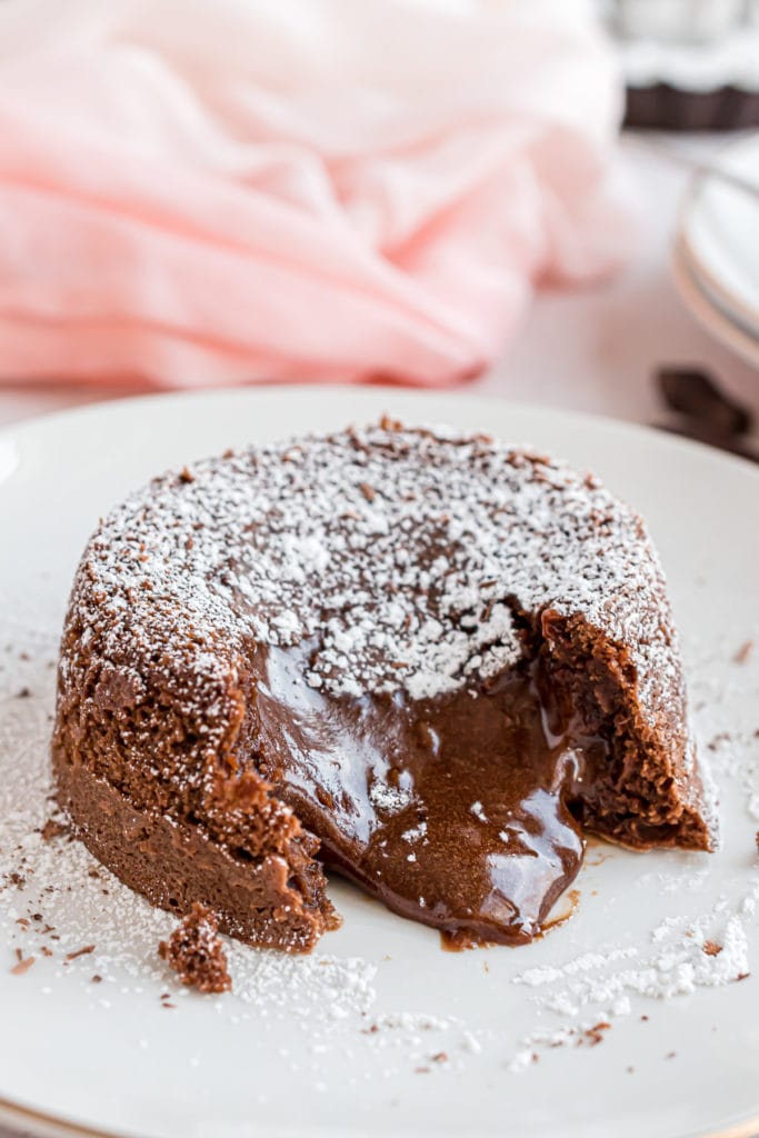 Molten chocolate lava cake on a white dish.