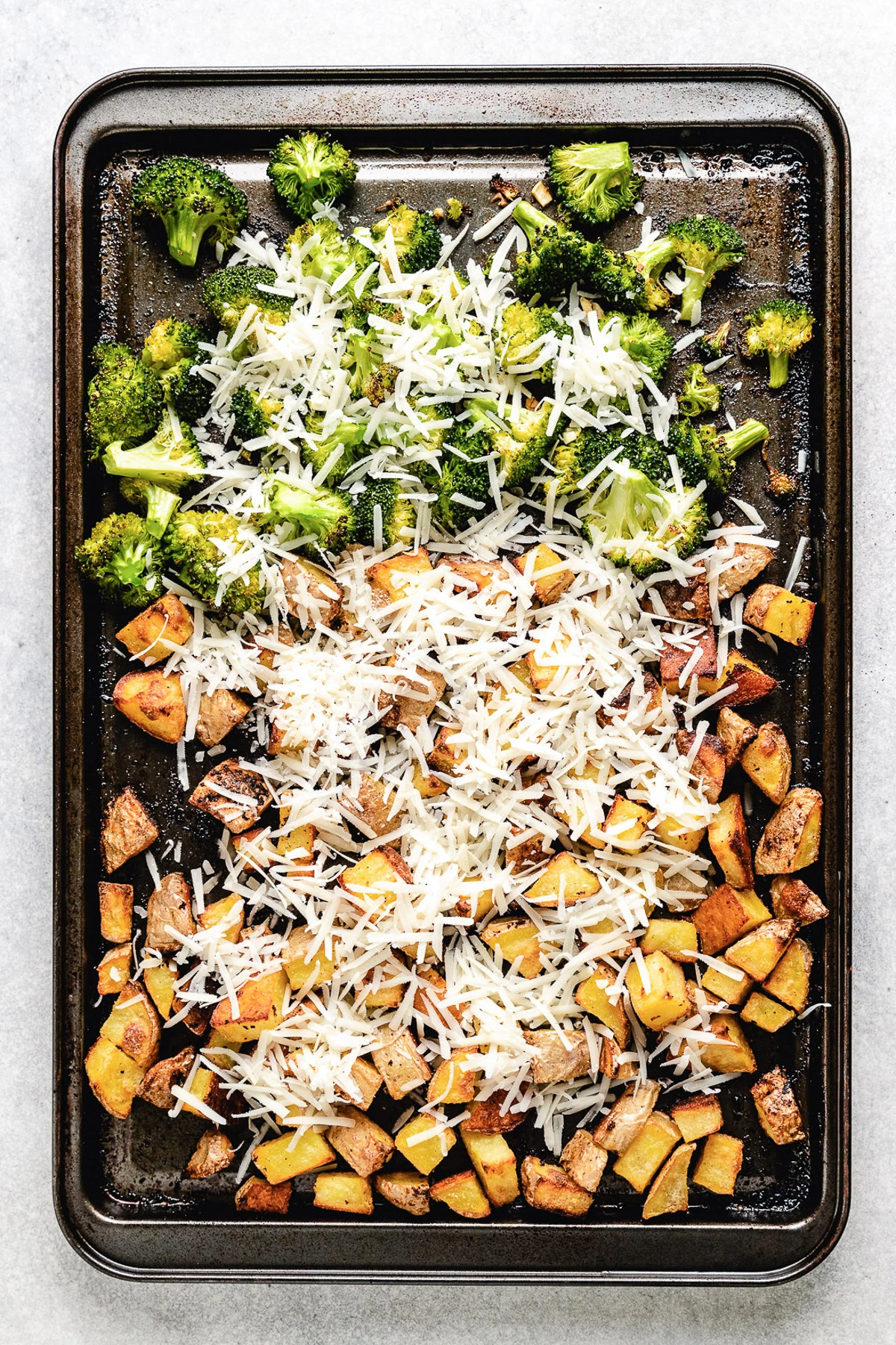 Parmesan cheese over potatoes and broccoli.