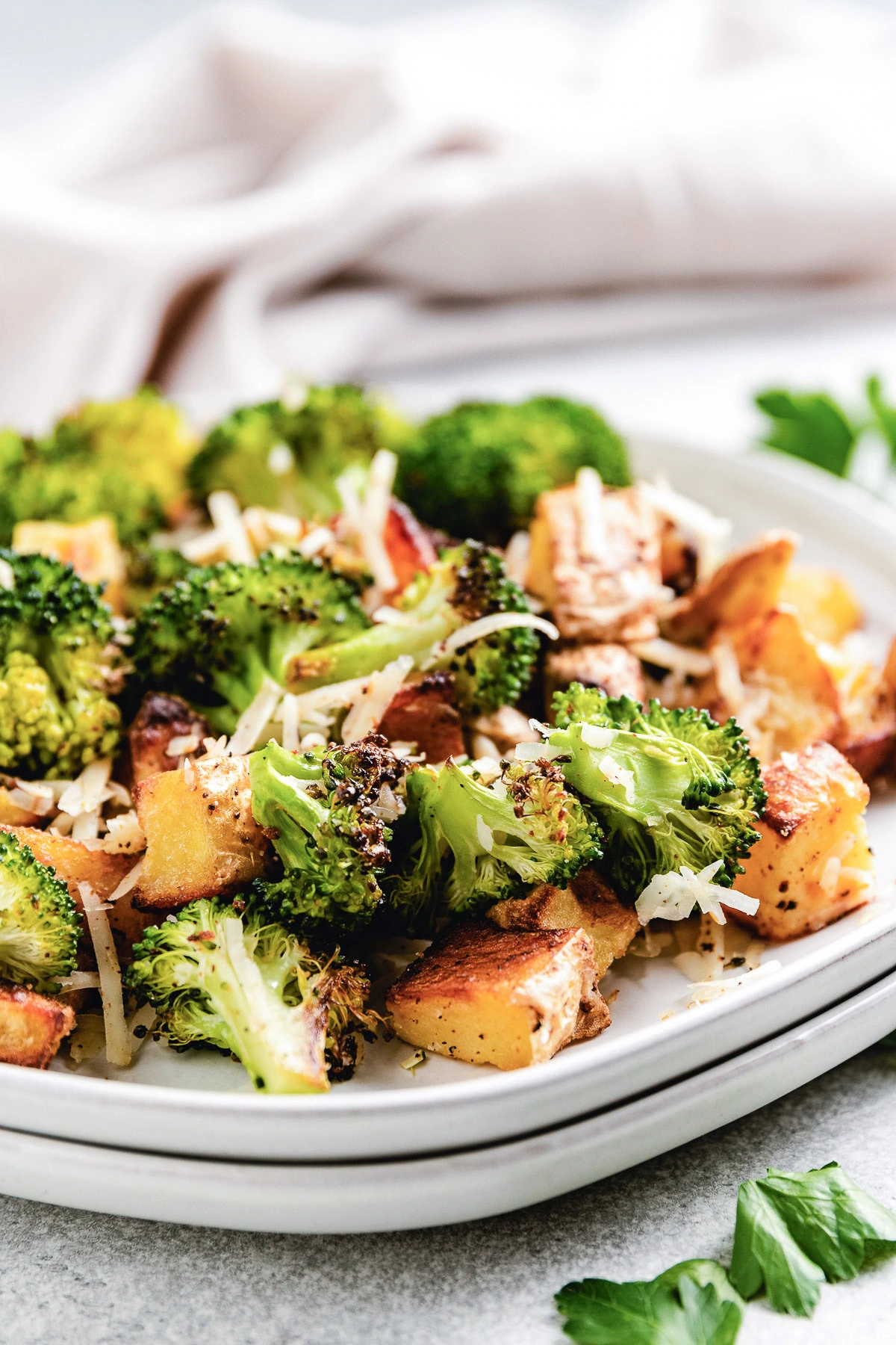 Roasted Potatoes And Broccoli Close up view of a plate of roasted potatoes and broccoli.