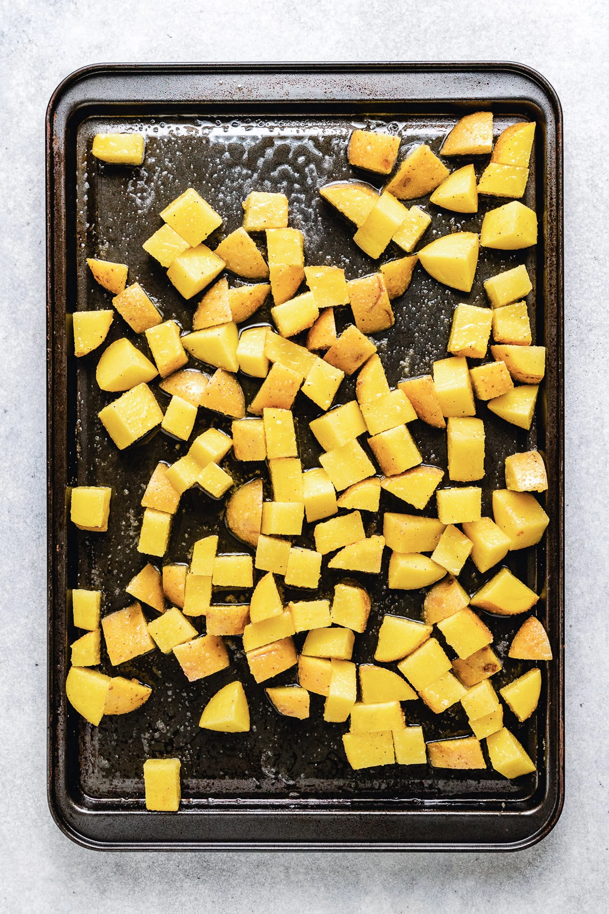 Diced potatoes on a sheet pan.