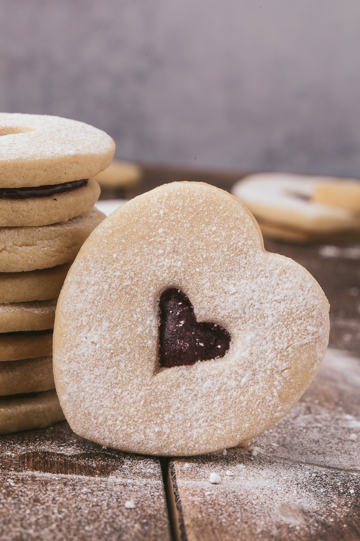 Close up view of a leaned over heart shaped cookie.