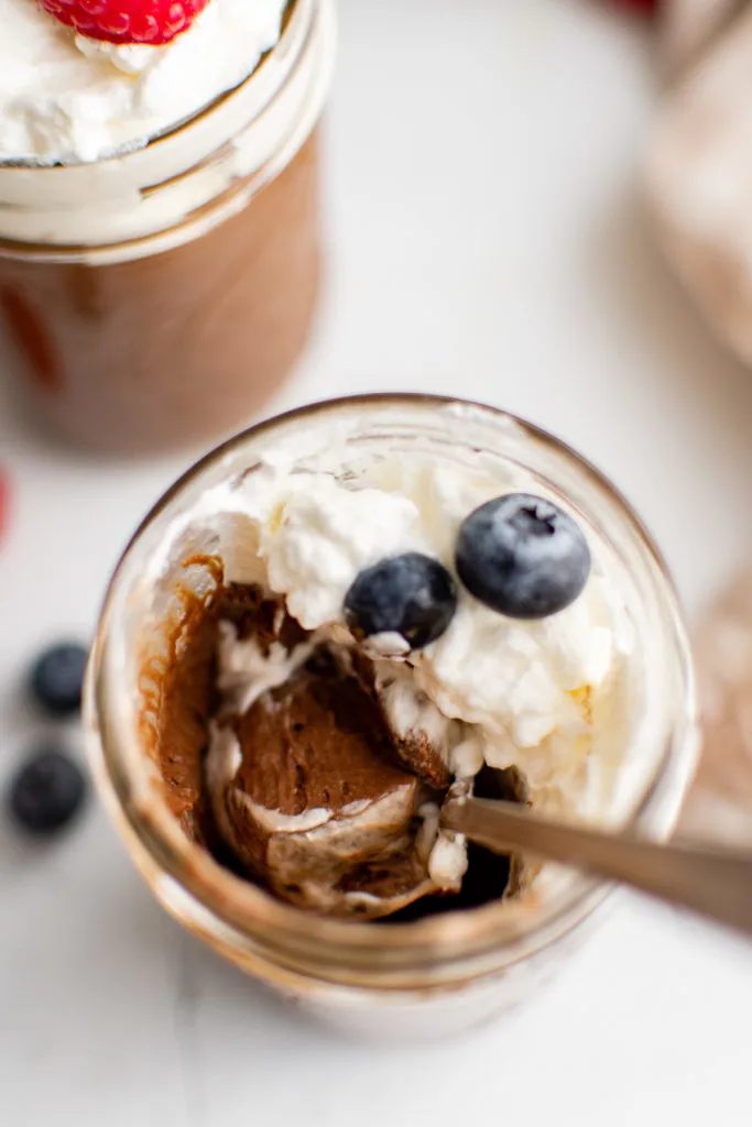 Top down view of a jar of chocolate mousse.