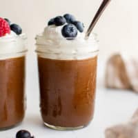 Jars filled with chocolate mousse desserts.
