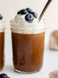 Jars filled with chocolate mousse desserts.