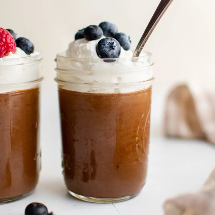 Jars filled with chocolate mousse desserts.