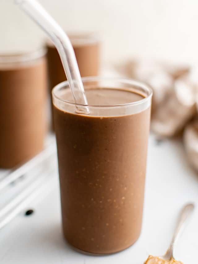 Smoothie in a glass with a straw.