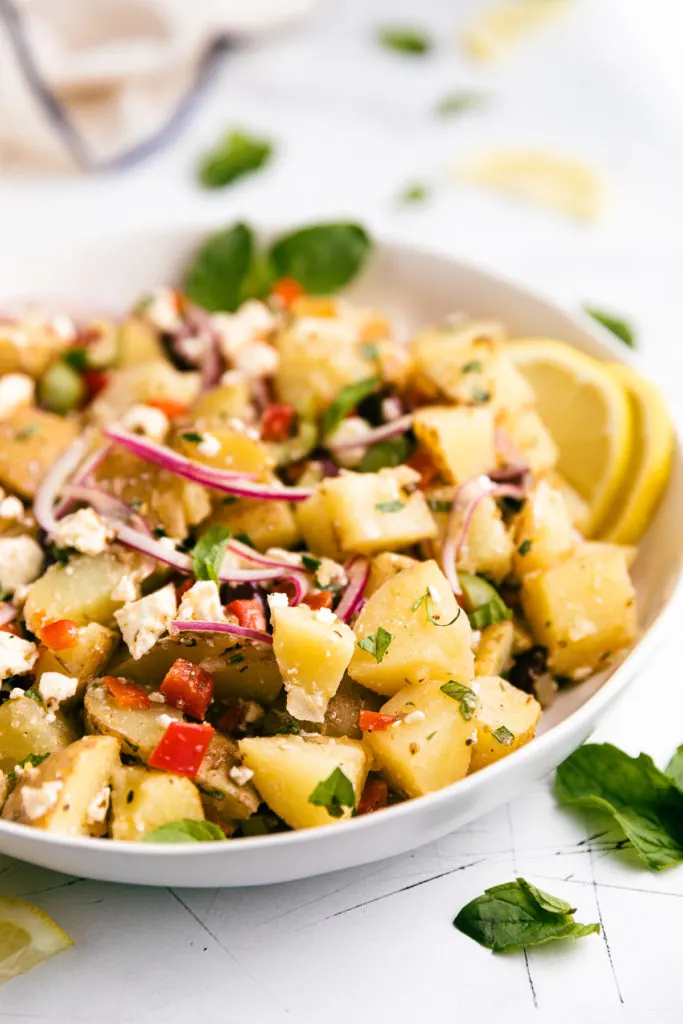 Angled view of mediterranean potato salad.