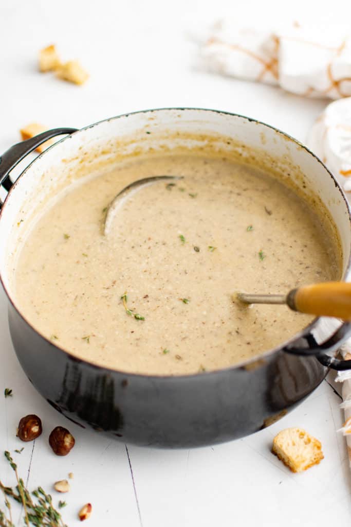 Side view of a large pot of soup.