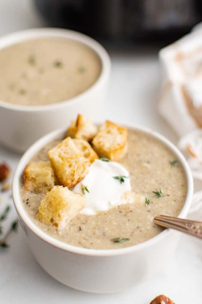 White bowls filled with soup and croutons.
