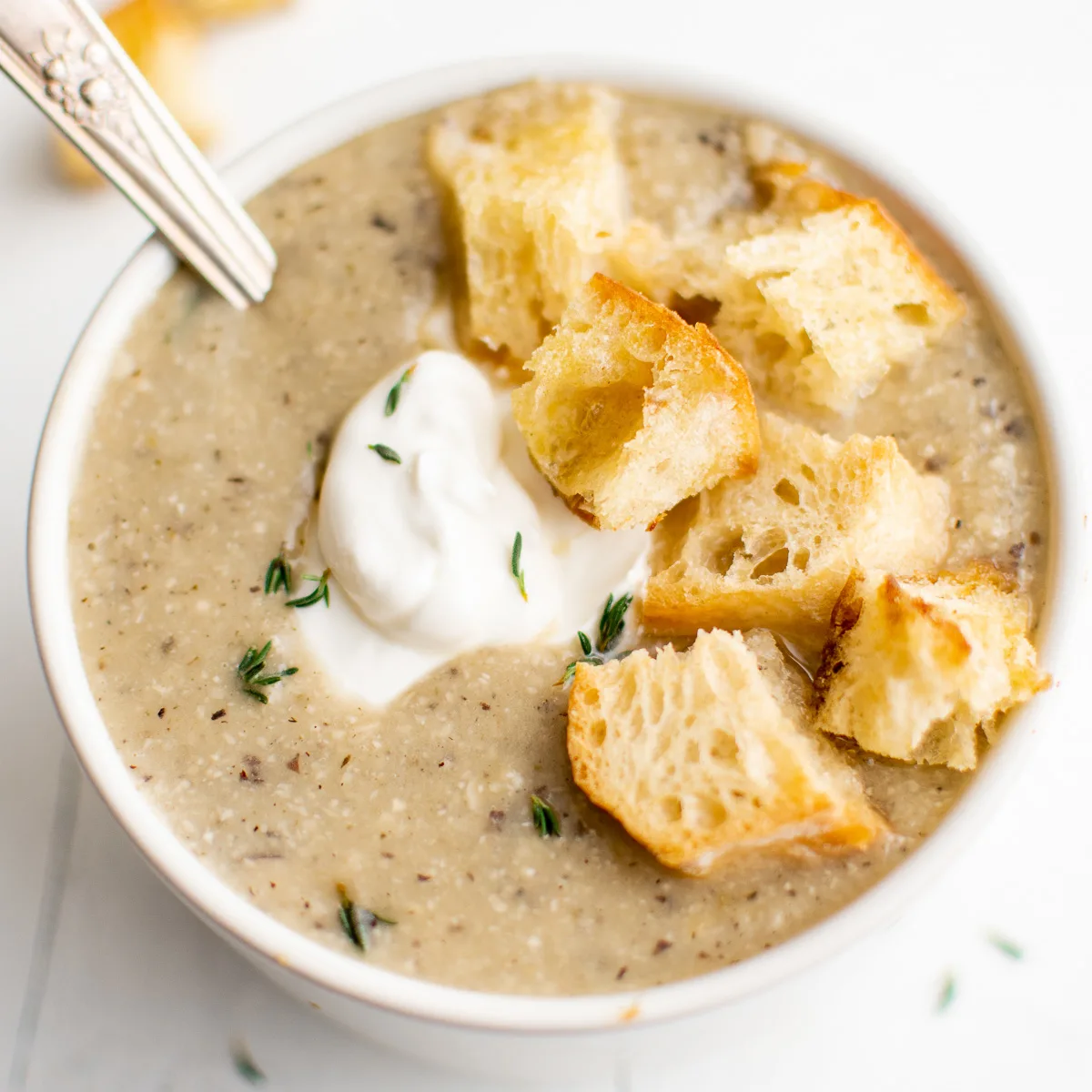 Angled view of hazelnut soup with croutons.