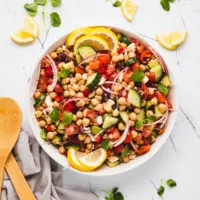 Top down view of mediterranean salad with lemons.