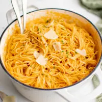 Large dutch oven of red pepper pasta.