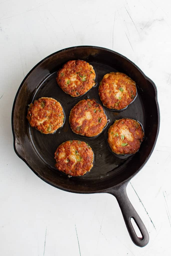 Cooked salmon croquettes in cast iron.