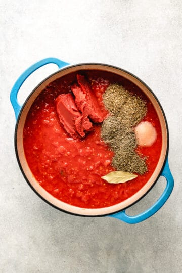 Tomatoes, tomato paste,  and seasonings in a pan.