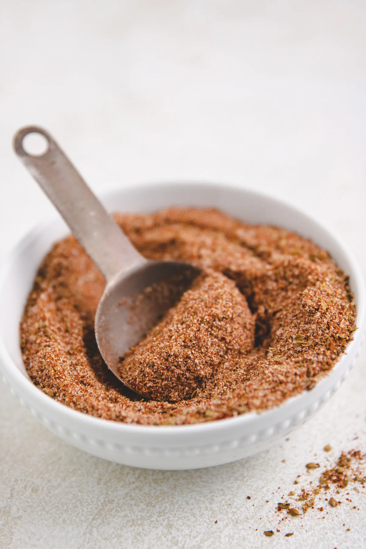 Small white bowl filled with homemade taco seasoning.