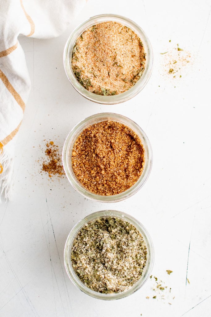 Top down view of various spice blends in jars.