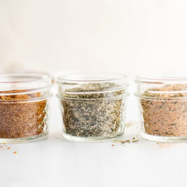 Three different spice blends in jars.