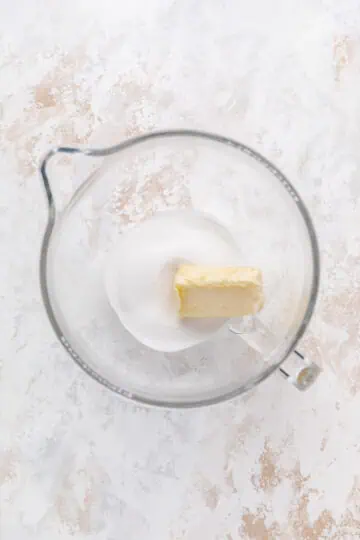 Butter and sugar in a bowl.