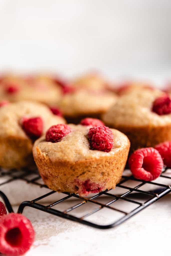 Raspberry muffin on a wire rack.