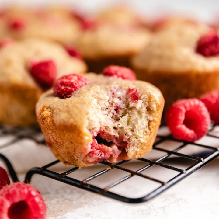 Bite taken out of a raspberry muffin.