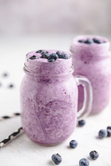 Two smoothies in glass mugs.
