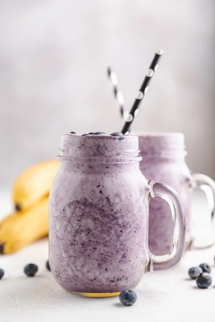 Two glasses filled with smoothies.