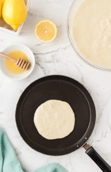 Pancake cooking on a pan.