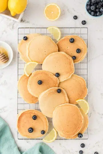 Cooked pancakes on a wire rack.