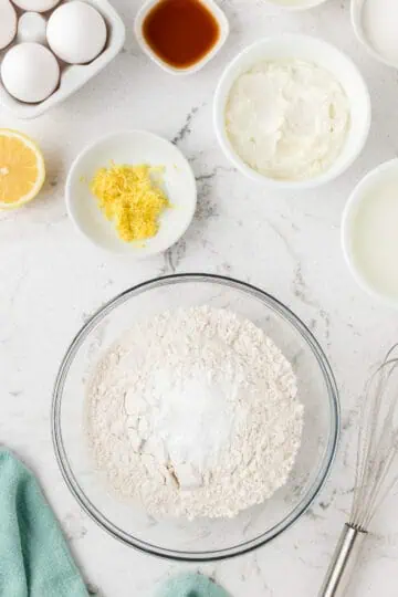 Flour, baking powder, baking soda, and salt in a bowl.