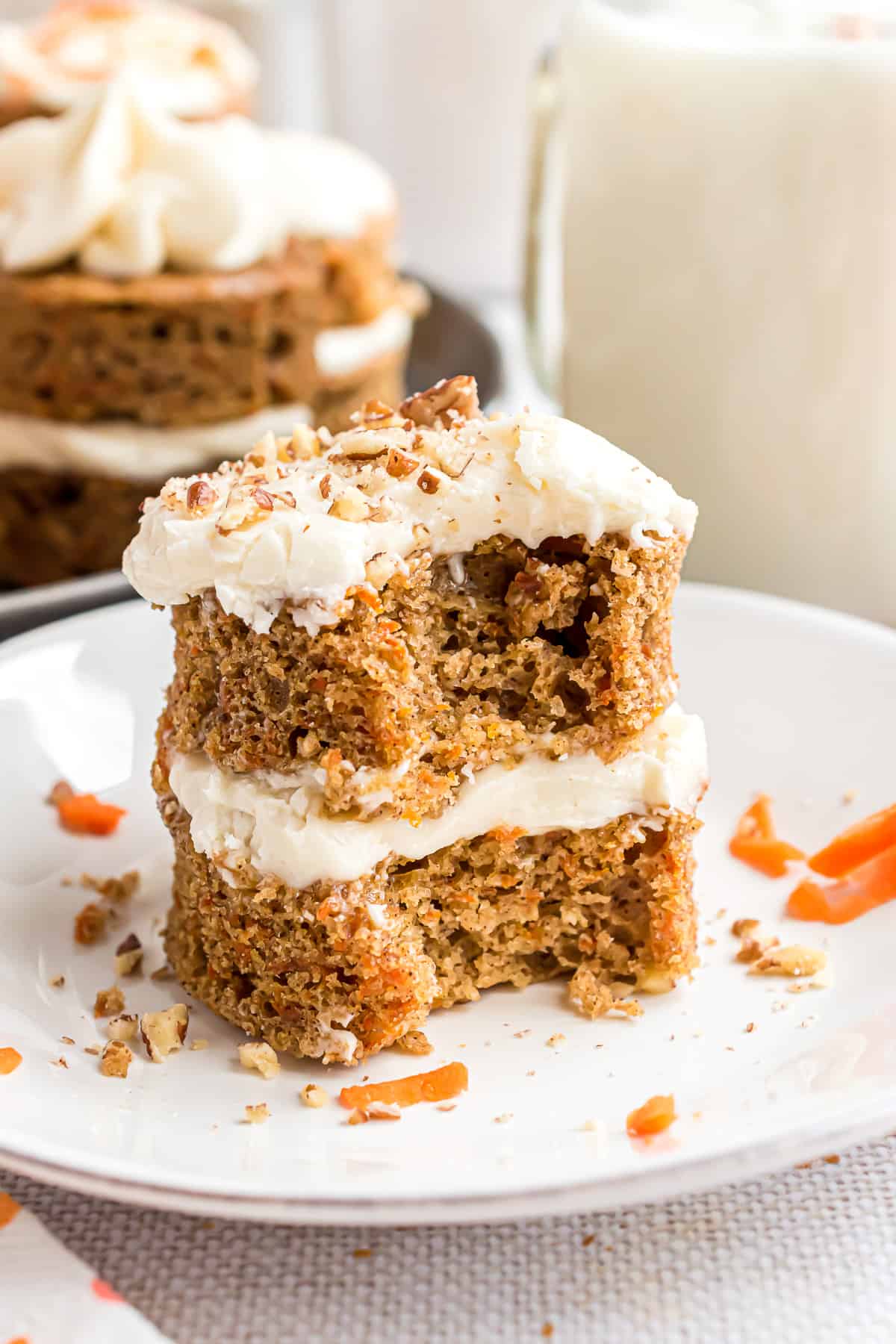 Bite taken out of a mini carrot cake.