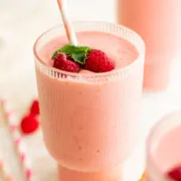 Peach raspberry smoothie with fresh fruit.