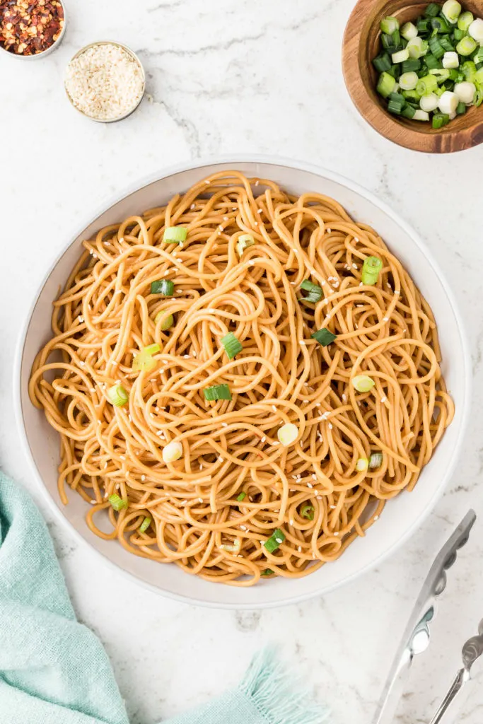 Top down view of a bowl of sesame noodles.