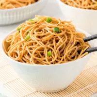 White bowl filled with sesame noodles.