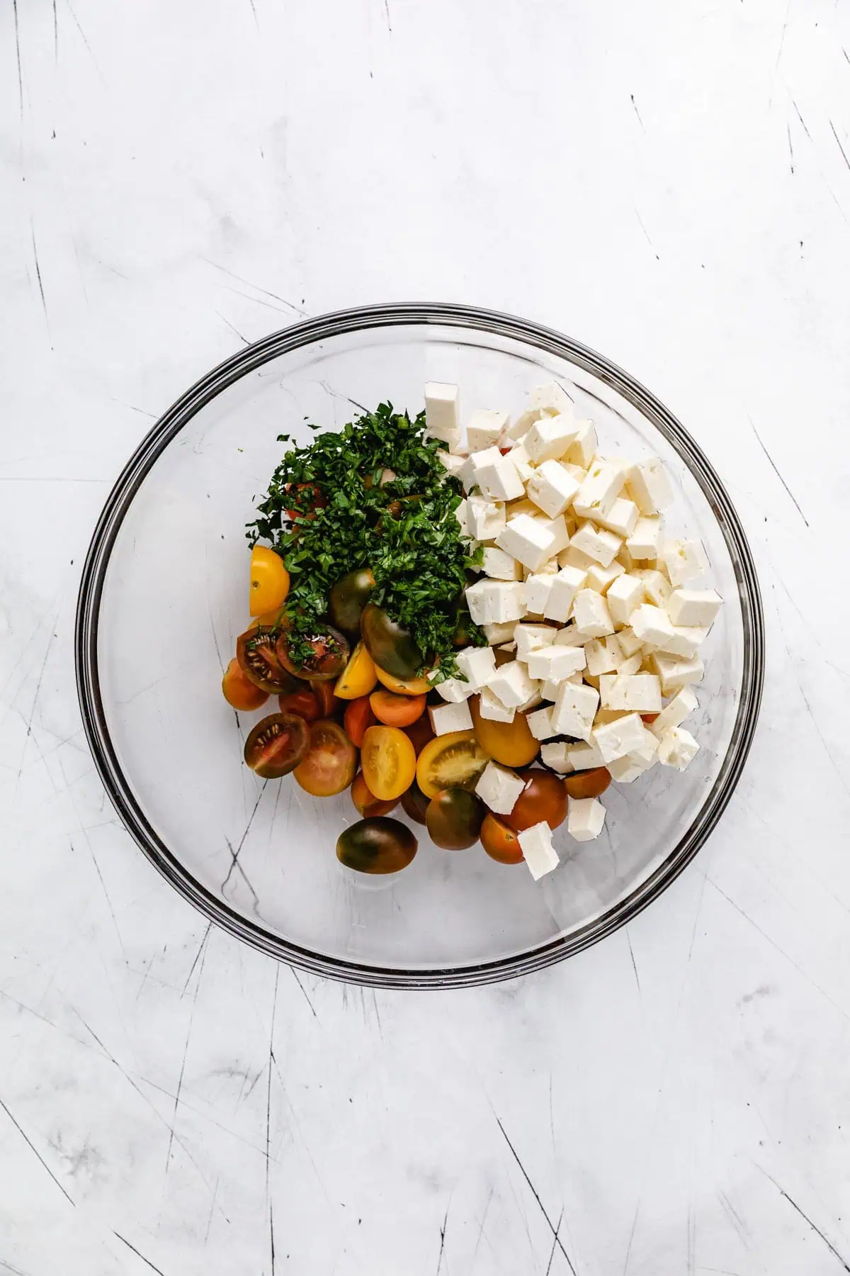 Tomatoes, bowls, and herbs in a bowl.