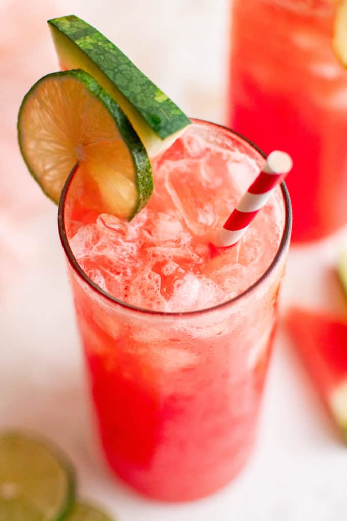 Top down view of a pink colored drink with a straw.