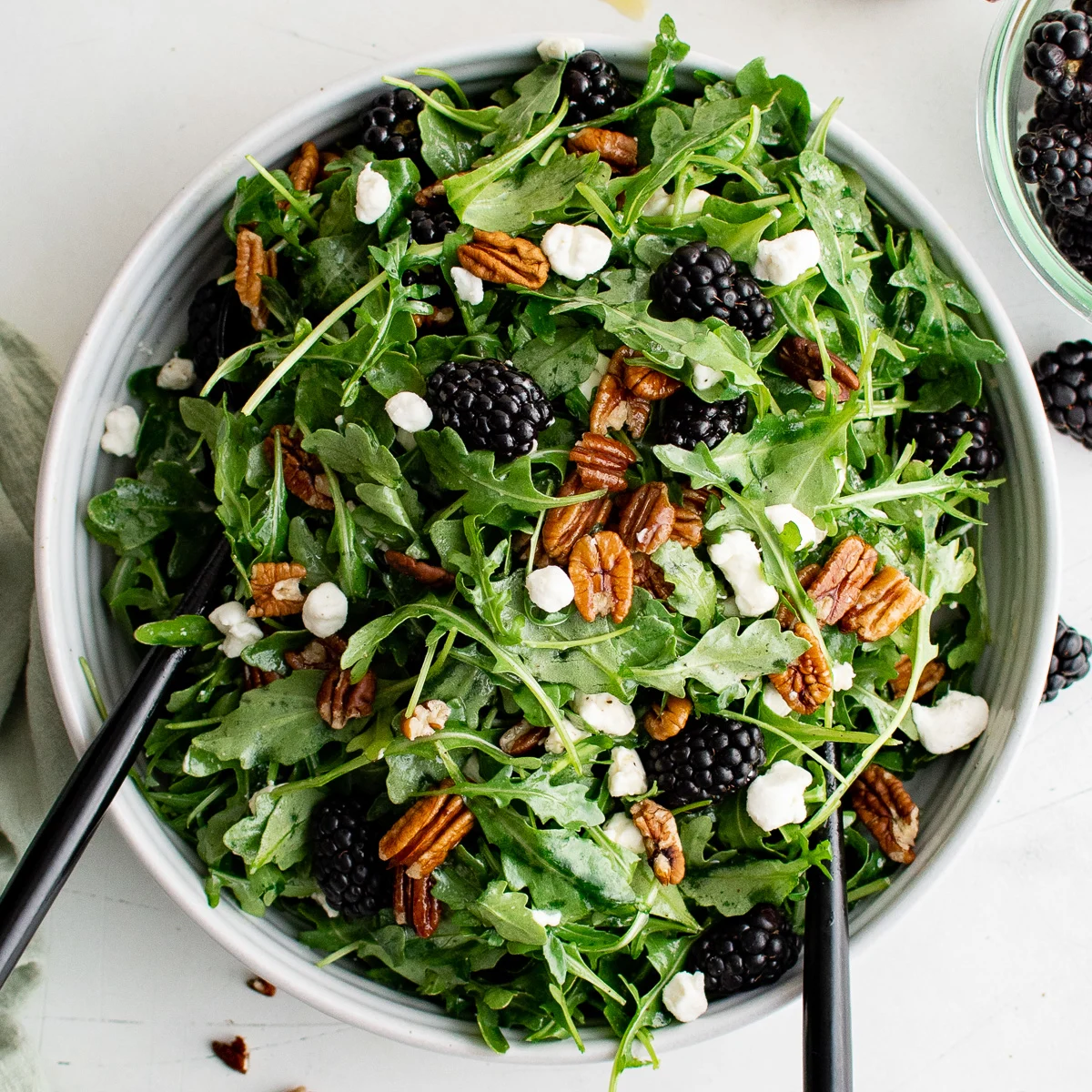 Top down view of blackberry goat cheese salad in a bowl.