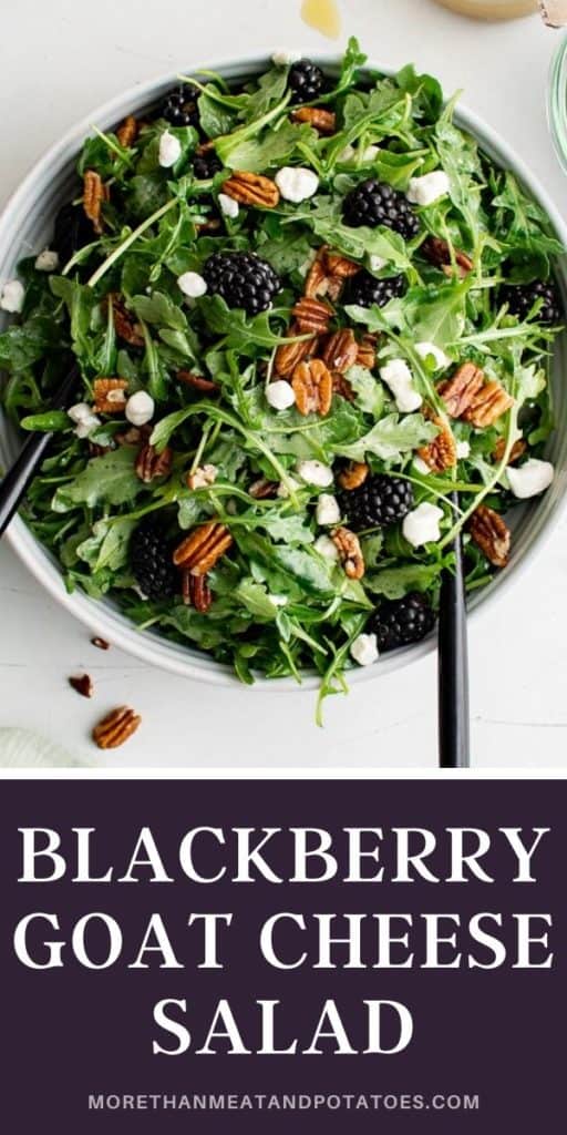 Top down view of a large blackberry goat cheese salad in a serving dish.