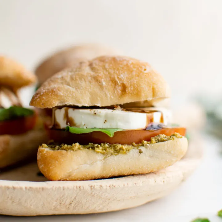 Side view of a pesto caprese sandwich.