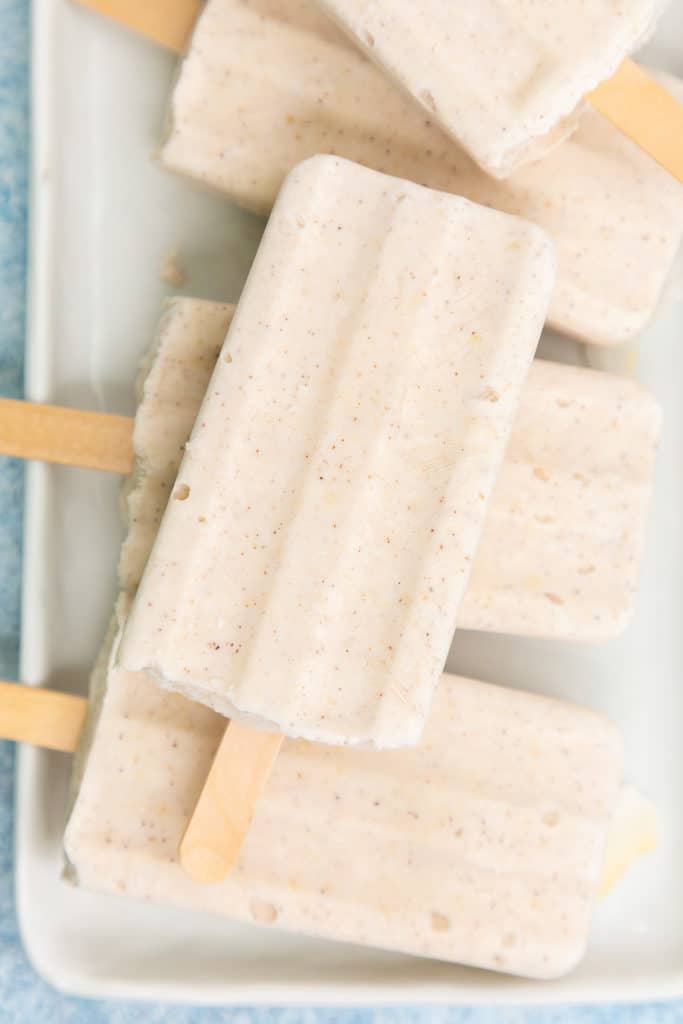 Close up view of a plate of coconut popsicles.