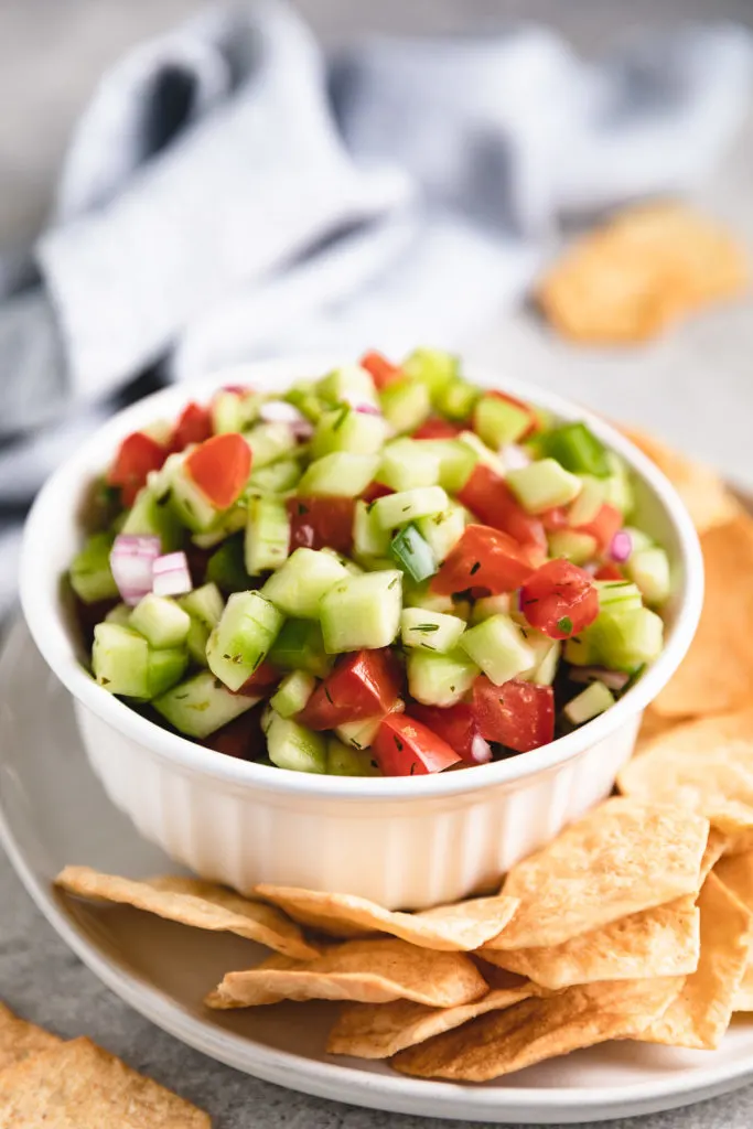 Large white ramekin filled with cucumber salsa.