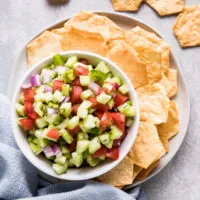 Chips and veggie salsa on a plate.