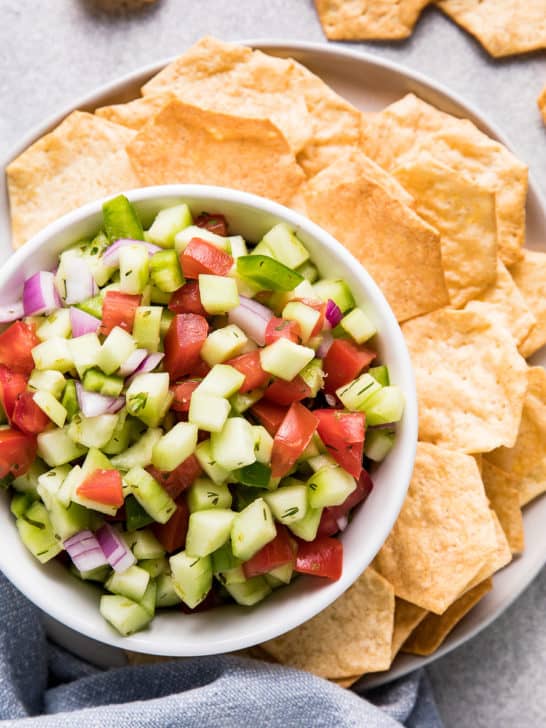 Chips and veggie salsa on a plate.