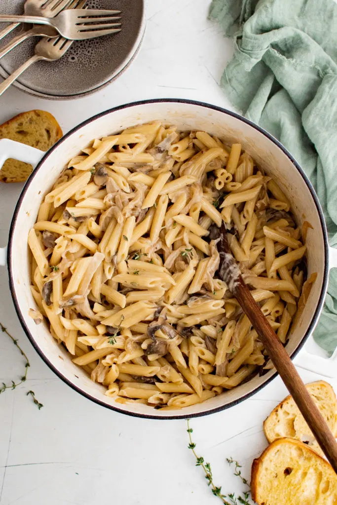 Top down view of onion pasta in a dutch oven.