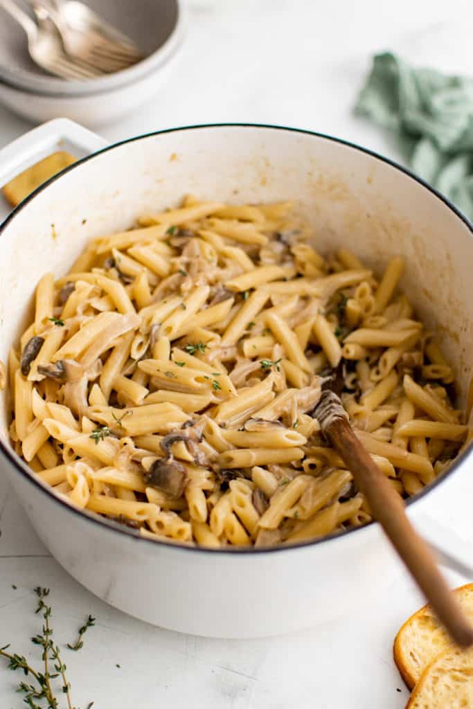 Angled view of pan of pasta with mushrooms.
