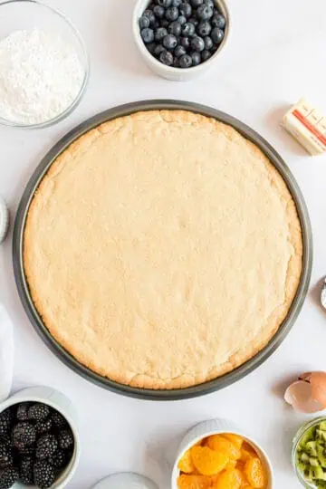 Unbaked cookie crust on a pan.