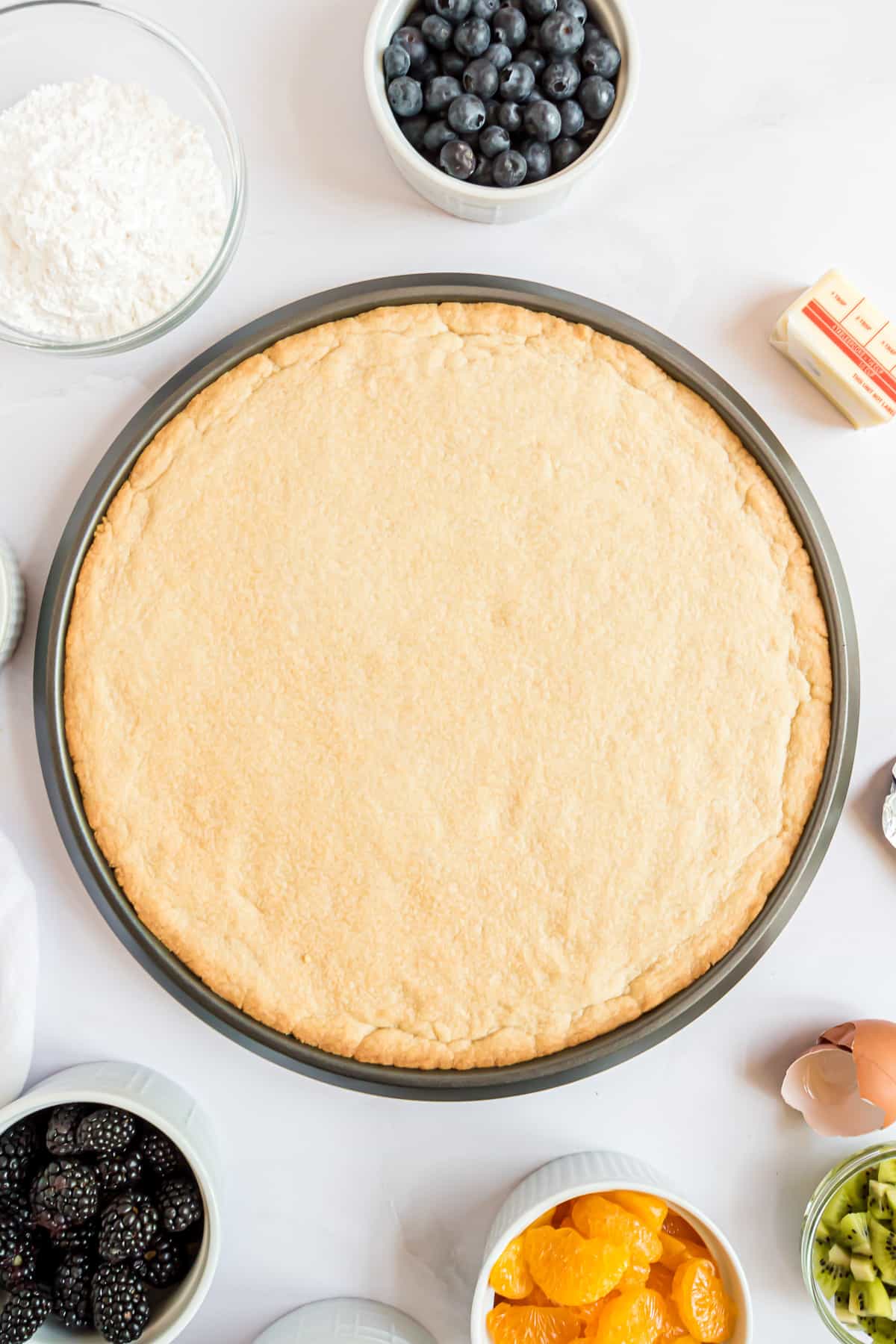 Unbaked cookie crust on a pan.