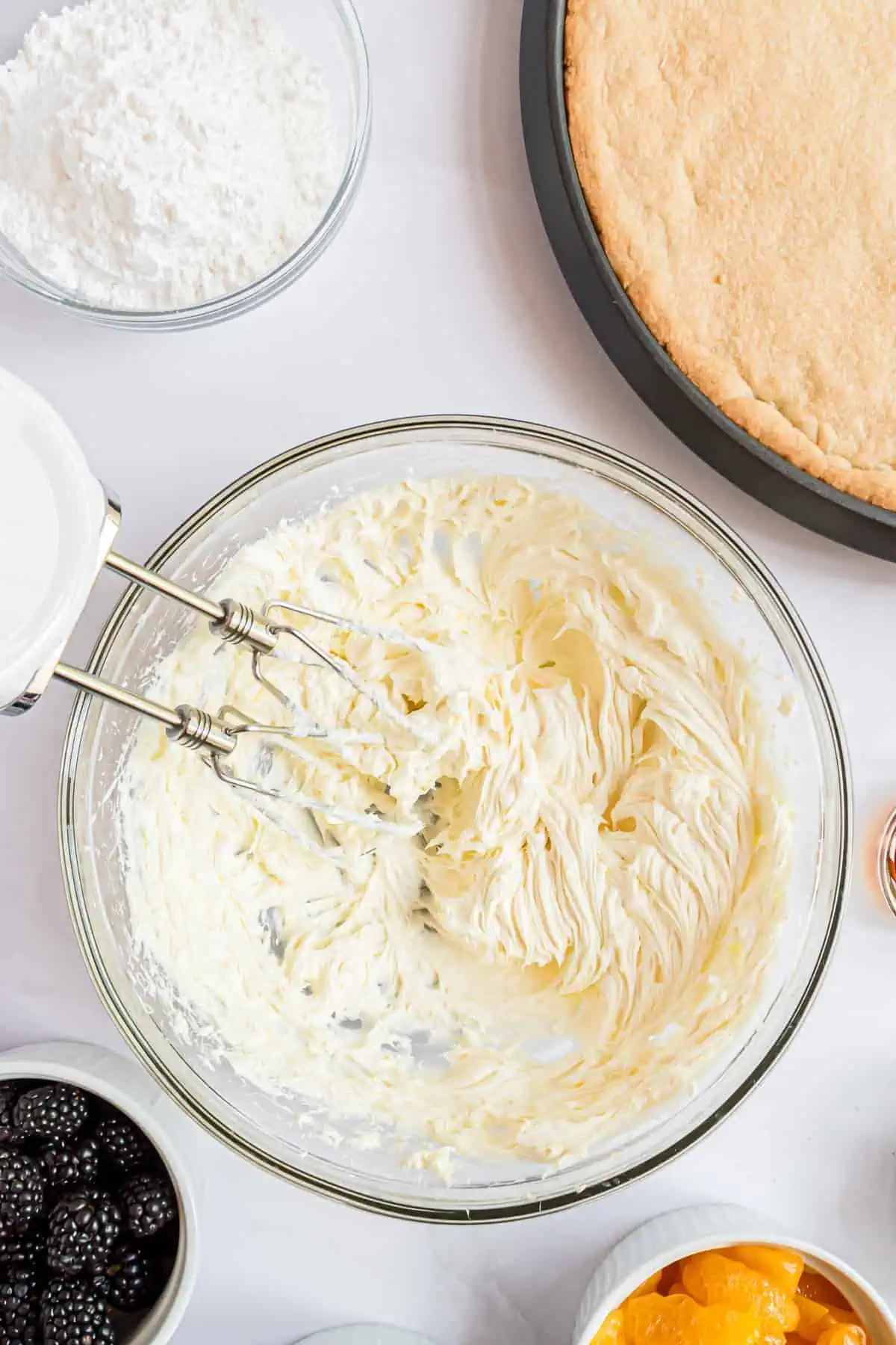 Cream cheese and butter mixed in a bowl.