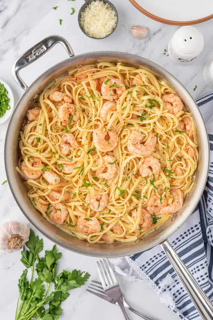 Garlic shrimp and pasta cooked in a skillet.