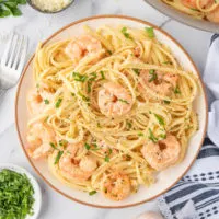 Shrimp and pasta on a dish.